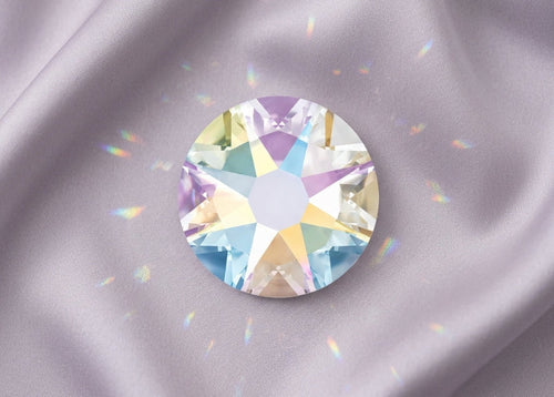 Multicolored gemstone on a gray fabric background. SS12 Crystal AB | Swarovski Crystals
