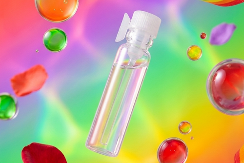 Clear bottle with white cap on a colorful background with rainbows and bubbles
