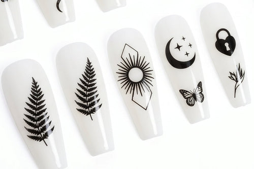 White nail art designs with black patterns on a white background