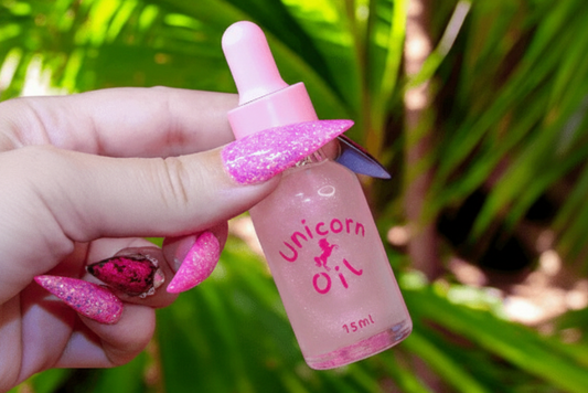 15ml glass dropper bottle of Tropical Peach Blossom Unicorn Cuticle Oil. Australian made cuticle care products featuring a shimmering golden-peach liquid.