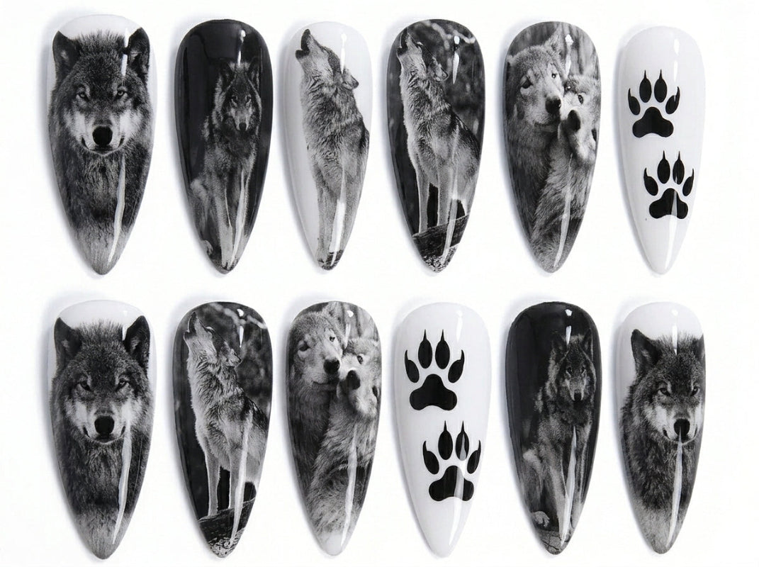 Nail art designs featuring wolves and paw prints on a white background