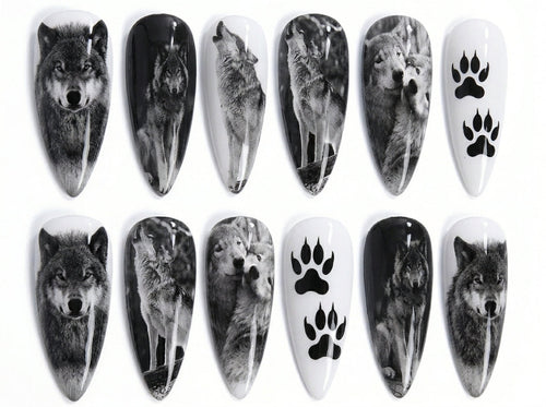 Nail art designs featuring wolves and paw prints on a white background