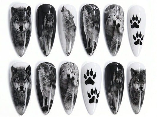 Nail art designs featuring wolves and paw prints on a white background