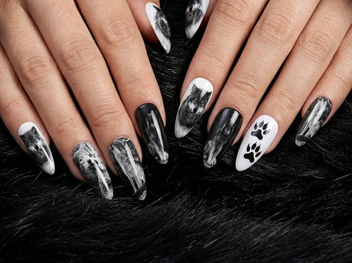 Close-up of hands with black and white paw print nail design on a dark fur background