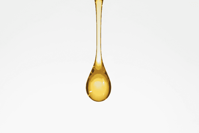 Yellow oil drop on a white background
