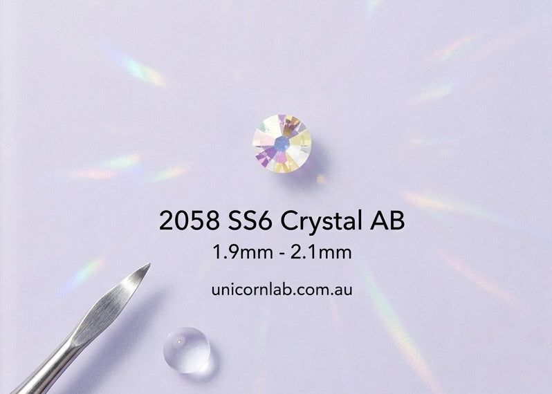 Crystal AB gemstone with size specifications on a clear stand against a light purple background. ab swarovski ss6
