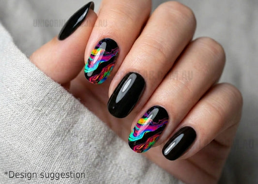 Nails with black polish and colorful abstract designs on a neutral background