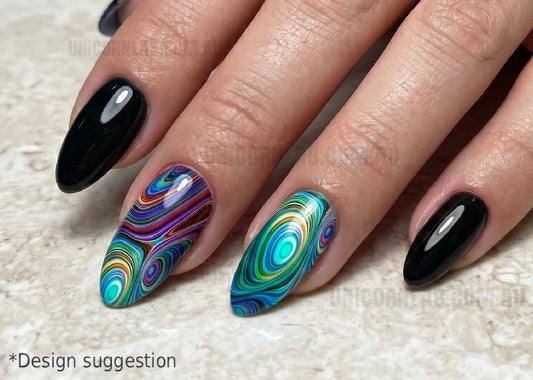 Nails with black and colorful swirl design on a textured surface