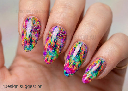 Multicolored nail art on a hand with a blurred background
