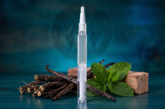 Clear cuticle oil pen for men with vanilla beans and mint leaves on a blue background. Australian made scented cuticle oil