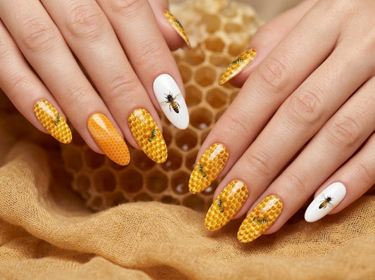 Nails with honeycomb and bee design on a textured fabric background