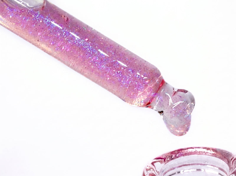 a macro shot of berry naught cuticle oil in a dropper