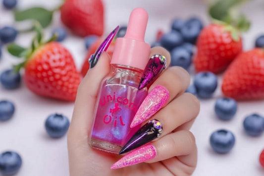 15ml glass dropper bottle of shimmering berry-scented oil and a boutique label. being held by a hand with pink nails