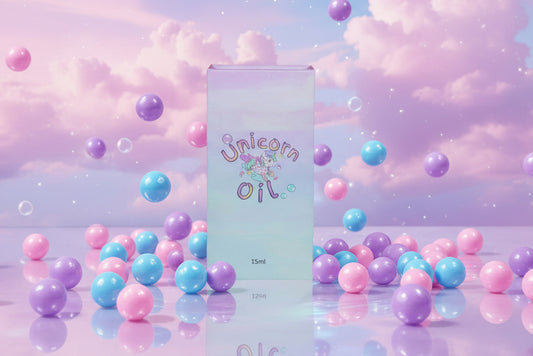 Bubblegum Unicorn Cuticle Oils luxury magnetic close style packaging surrounded by bubble and bubblegum falling. Product is in front of a pastel cloud sky - Unicorn Lab