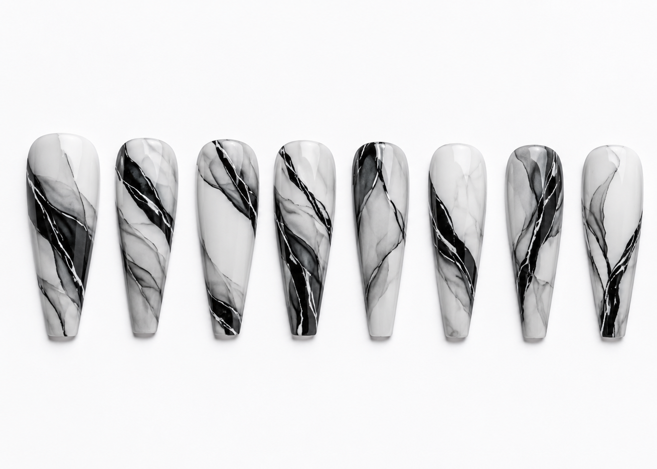 Marble-patterned nails arranged in a row on a white background