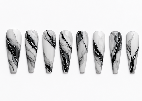 Marble-patterned nails arranged in a row on a white background