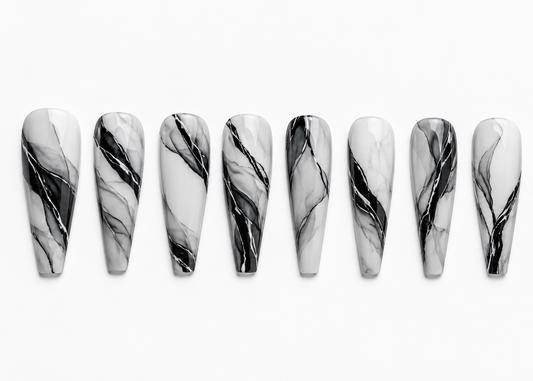 Marble-patterned nails arranged in a row on a white background