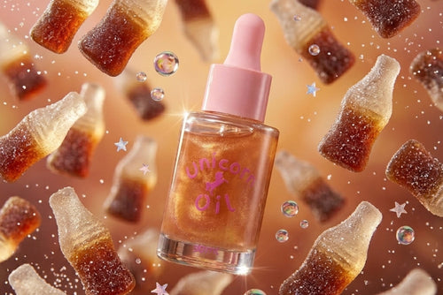 Glass bottle labeled 'Unicorn Oil' with gummy bear-like shapes around it on a brown background. scented shimmer nail oils, australian made serums