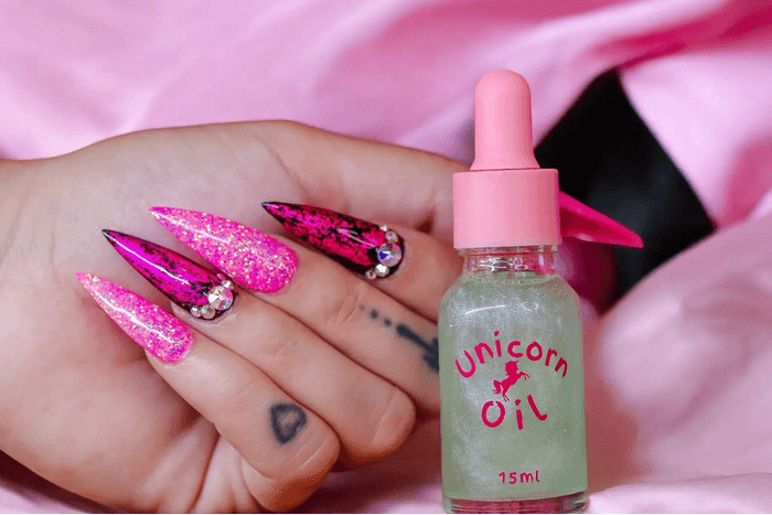 15ml dropper bottle luxury French Pear Unicorn Cuticle Oil serum for professional salons. with pink gliter nails on pink background