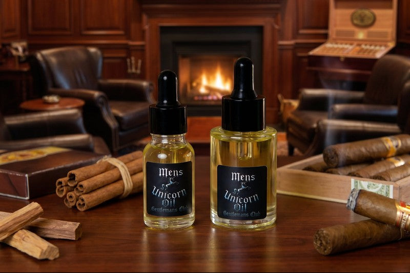 Two bottles of 'Men's Unicorn Oil' on a wooden table with a fireplace and cigars in the background.