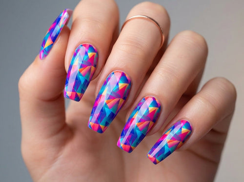 Hand with colorful geometric nail art on a neutral background