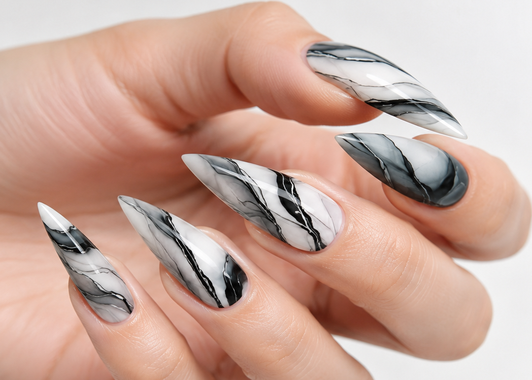 Hand with marble nail design on a white background