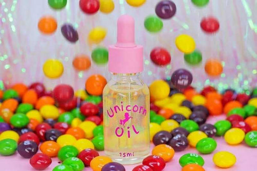Skittles cuticle oil dropper bottle with scattered candy, hydrating nail serum for dry brittle nails