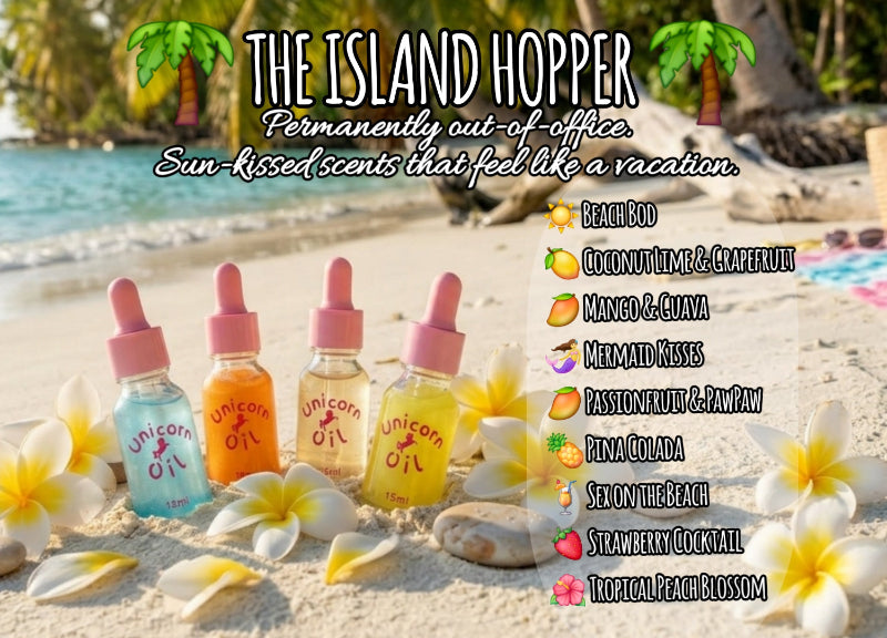 Four bottles of 'Unicorn Oil' on a beach with flowers and text about island-themed products.