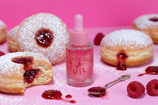 Jam donut scented cuticle oil, surrounded by raspberry jam donuts, Australian made cuticle oils.