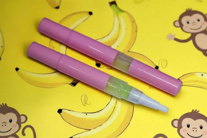 3ml twist cuticle oil pen of Monkey Farts Unicorn Cuticle Oil featuring a tropical shimmering liquid.