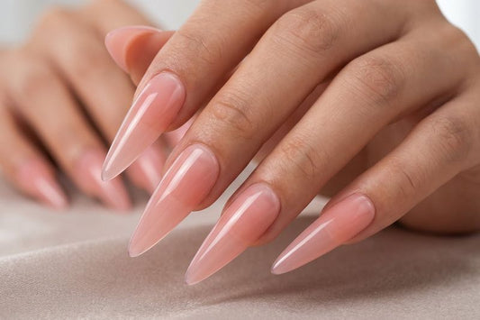 Close-up of hands with pink nail polish on a neutral background