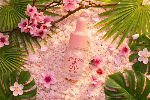 5ml glass dropper bottle of Tropical Peach Blossom scented nail serum. Australian made cuticle care products featuring a shimmering golden-peach liquid.