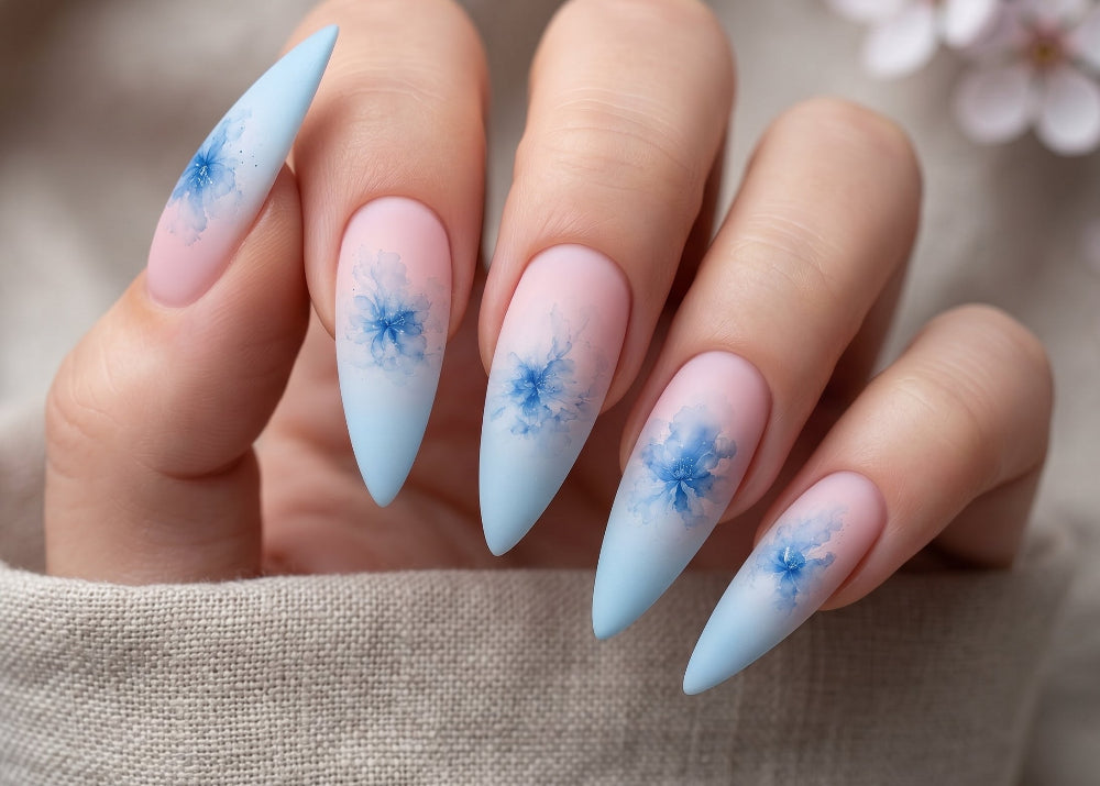Nails with blue floral designs on a neutral background
