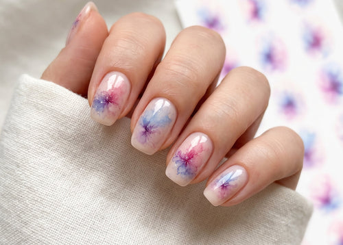 Nails with floral nail art on a white background
