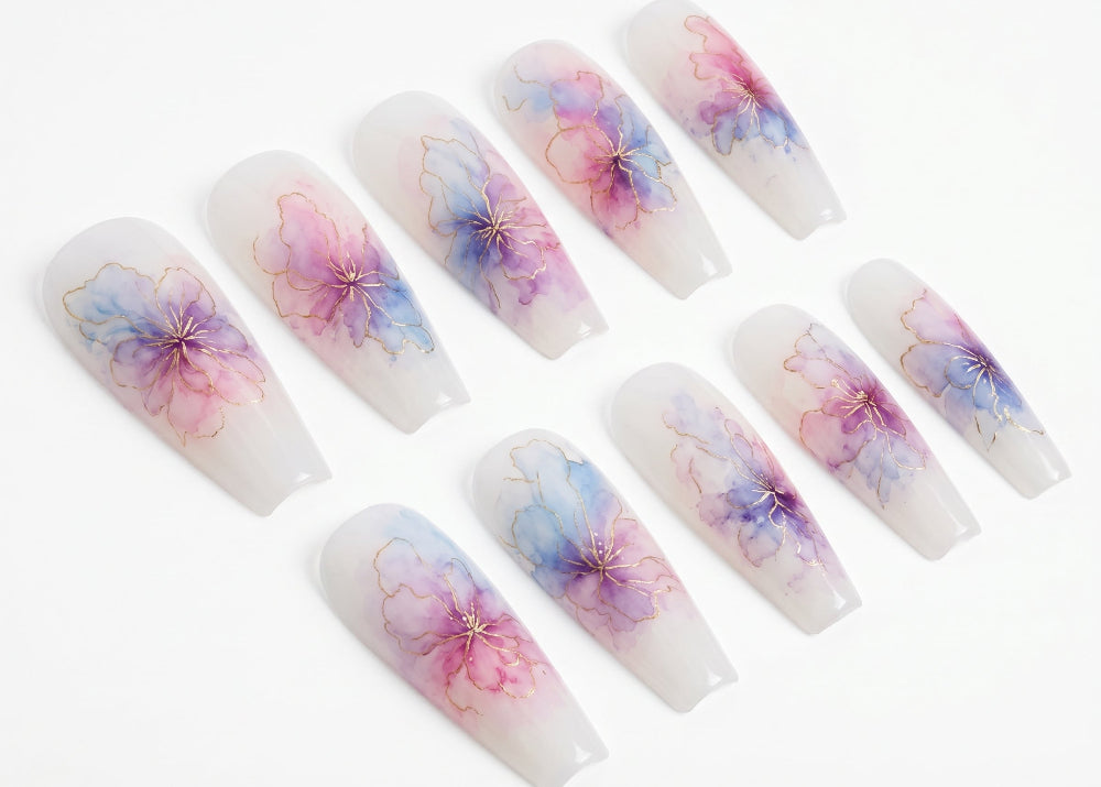 Set of press-on nails with floral designs on a white background