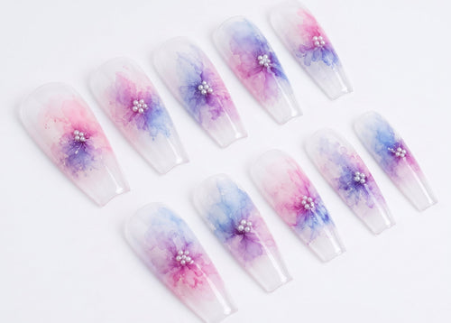 Set of press-on nails with watercolor floral design on a white background
