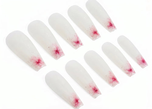 Set of white nail extensions with red floral patterns on a white background