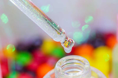 A close up image of the Skittles Unicorn Cuticle Oil dropper- Unicorn Lab