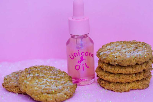 15ml glass dropper bottle of Sugar Cookie Unicorn Cuticle Oil, showing a shimmering, golden bakery-scented serum.