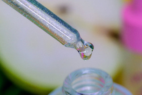 French Pear Unicorn Cuticle Oil - marco shot of green sparkly cuticle oil