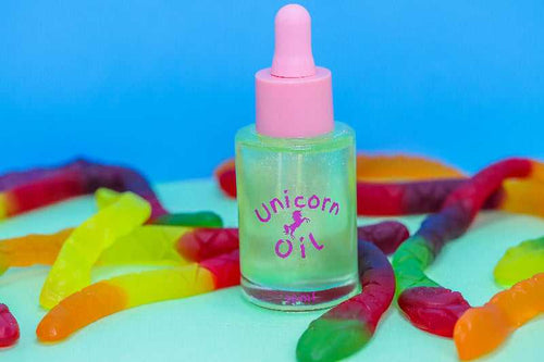 Killer Python Unicorn Cuticle Oil 30ml on a table with snake lollies - Unicorn Lab
