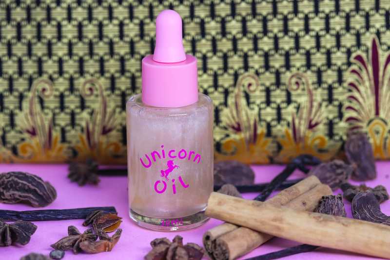 Vanilla Spice & Everything Nice Unicorn Cuticle Oil in large 30ml luxury sized botte with pink dropper. cinnamon sticks, star anise and fresh vanilla pods are scattered around product